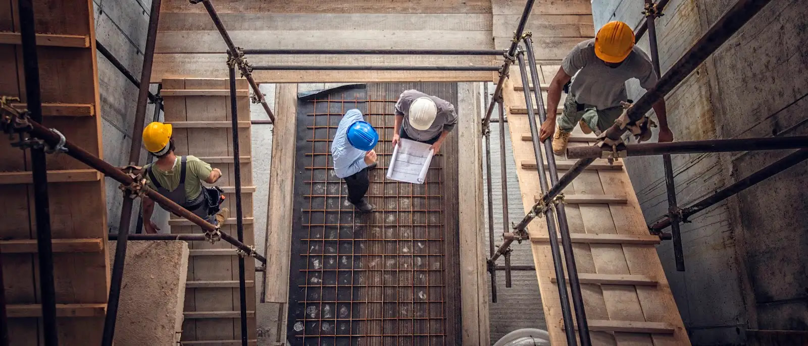 Construction workers and architects at a construction site viewed from above